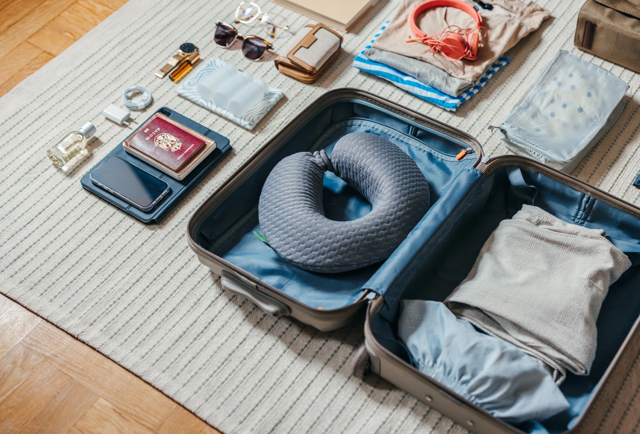 Open suitcase with travel essentials laid out for packing