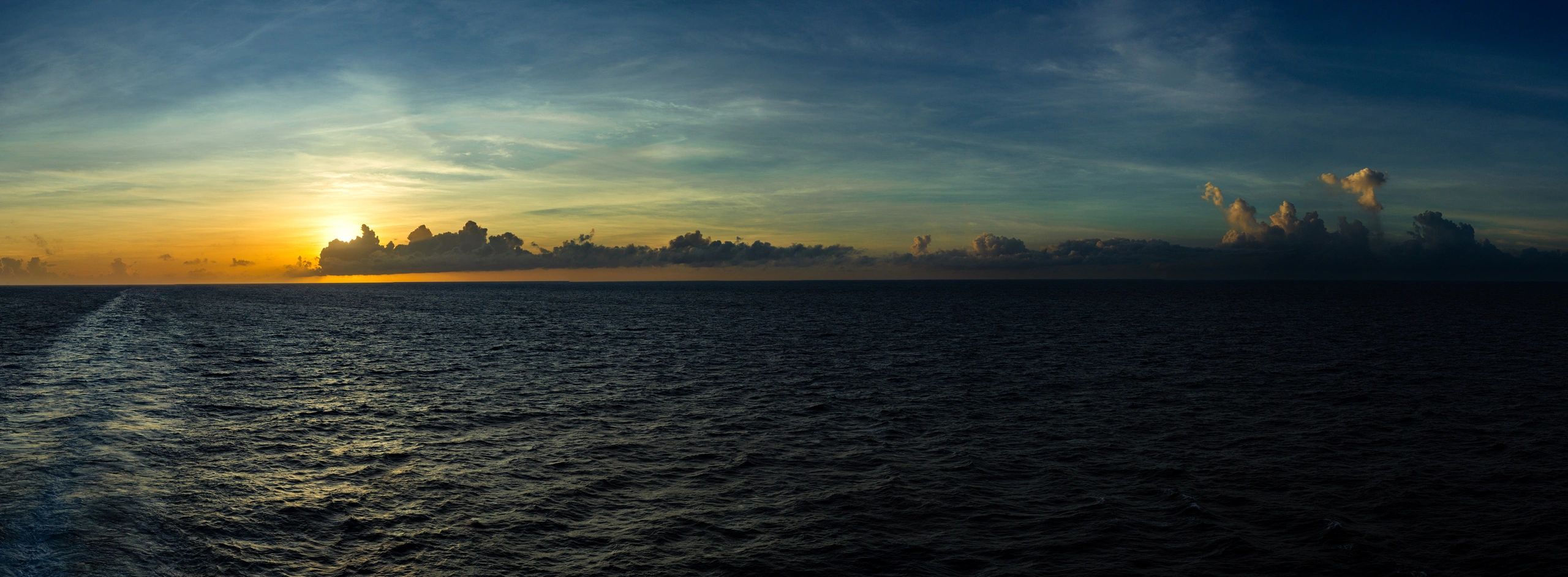 Ocean sunset with ship wake